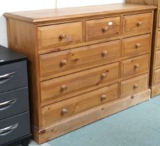 A contemporary pine bank of drawers with three short over three long alongside three short drawers