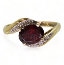 A 9ct gold ring, of QVC design, set with garnet and diamonds, size T, weight 2.7gms Condition