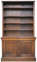 A Victorian stained oak open library bookcase with four open shelves on base with pair of panelled