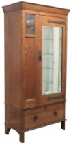 AN OAK ARTS & CRAFTS HARRIS LEBUS MIRROR DOORED WARDROBE  with plain shaped cornice over single