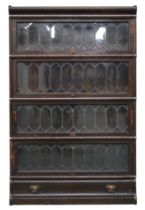 A 20TH CENTURY STAINED OAK SECTIONAL BOOKCASE  with shaped top over four leaded glass lift doors