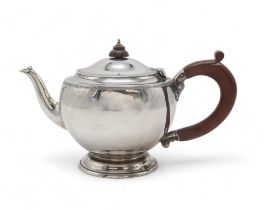 A GEORGE V SILVER TEAPOT by Edwards & Sons, London 1930, of compressed circular form, with engine-