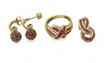 RUBY JEWELS A ruby crossover ring, mounted in yellow metal stamped '9', finger size K, with a 9ct