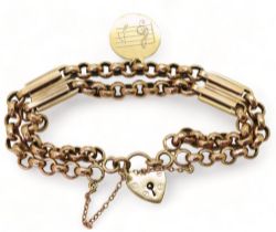 A VINTAGE BRACELET with facet cut round links and double baton links a heart shaped clasp and