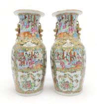 A PAIR OF CANTON BALUSTER VASES Painted with panels of figures, birds, insects and foliage, within