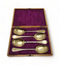 A CASED SET OF GEORGE III SILVER GILT SERVING SPOONS by Charles Mash, Dublin 1821, with an