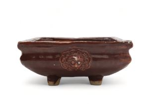 A CHINESE AUBERGINE GLAZED SQUARE CENSER The shoulder applied with a pair of animal mask handles,