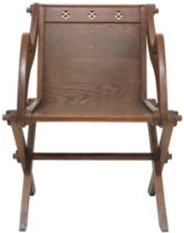 A VICTORIAN OAK ECCLESIASTICAL STYLE GLASTONBURY CHAIR backs pierced with ecclesiastical motifs