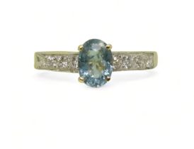 AN 18CT GOLD AQUAMARINE AND DIAMOND RING set with an oval cut aquamarine, with four pave set