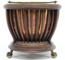 A 19TH CENTURY REGENCY STYLE COPPER COAL BUCKET  with brass swing handle within circular stand