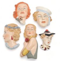 A COLLECTION OF CZECHOSLOVAKIAN ART DECO WALL MASKS all of girls' heads, including a Royal Dux