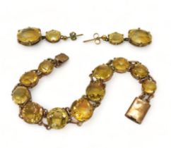 A CITRINE BRACELET set with round facet cut citrines that taper gently from 12.3mm to 8.4mm, with