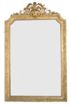 AN 18TH CENTURY STYLE GILT GESSO FRAMED WALL MIRROR  with scrolled floral surmount over shaped