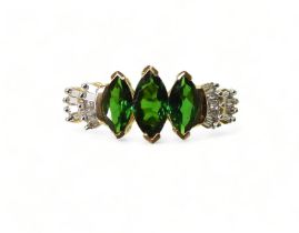 A RUSSIAN DIOPSIDE AND DIAMOND RING set with three marquis cut Russian diopsides, with baguette