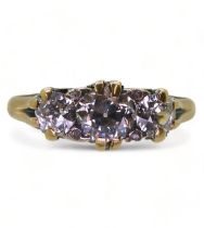 A SCROLL MOUNTED DIAMOND RING the bright yellow mount set with three old cut diamonds, with an