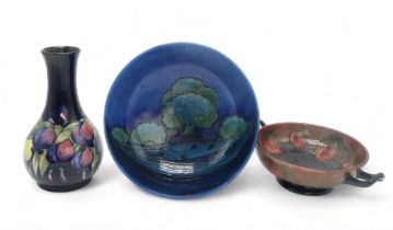 A COLLECTION OF MOORCROFT POTTERY including a Moonlit Blue bowl, 26cm diameter, a flambe leaf