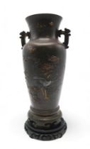 A JAPANESE BRONZE TWO HANDLED VASE Cast and decorated with birds amongst peonies,magnolia and