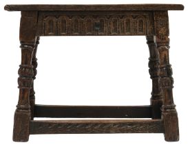 A 17TH CENTURY STYLE OAK JOINT STOOL  with rectangular top over carved friezes on turned supports