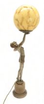 AN ART DECO GILDED SPELTER LADY LAMP modelled standing on tiptoes, holding the glass ball shade