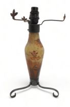 A DAUM NANCY GLASS LAMP BASE decorated with meadow flowers and grasses, with wrought iron base and