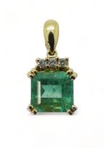 AN EMERALD AND DIAMOND PENDANT set in 18ct gold, set with a step cut emerald of approx 6.8mm x 6.