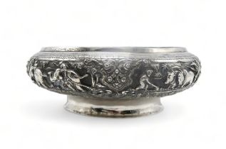 A BURMESE WHITE METAL PRESENTATION BOWL Decorated with oxen pulling carts and a boat divided by