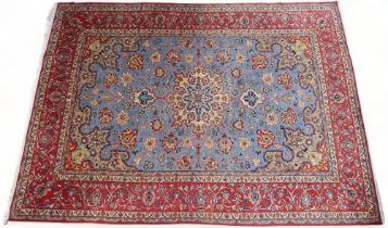 A LIGHT BLUE GROUND TABRIZ RUG  with multicoloured sunburst central medallion on floral patterned