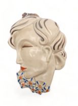 A CLARICE CLIFF WALL MASK circa 1936, moulded as a lady in profile with blue and orange flowers