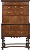 AN 18TH CENTURY WALNUT VENEERED CHEST ON STAND  top chest with three short over three long drawers