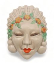 A CLARICE CLIFF MASK WALL POCKET circa 1936, moulded as a lady's head with orange and yellow