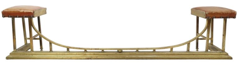 AN EDWARDIAN BRASS CLUB FENDER  with pair of brown leather upholstered seat pads on square