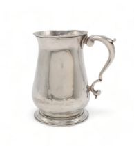 A GEORGE II SILVER TANKARD London 1757, maker's mark rubbed, of plain baluster form, with a