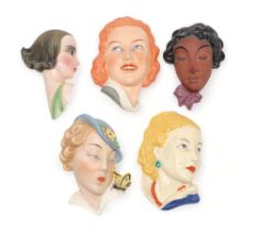 A COLLECTION OF CZECHOSLOVAKIAN ART DECO WALL MASKS all of girls' heads, including a Royal Dux