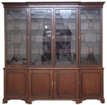 A 19TH CENTURY MAHOGANY BREAKFRONT BOOKCASE  with moulded cornice over four astragal glazed doors on