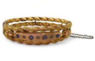 A 9CT EDWARDIAN BANGLE set with blue gems and rose cut diamond accents to the double barley twist