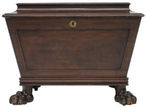 A 19TH CENTURY MAHOGANY SARCOPHAGUS CELLARETTE  with hinged lid concealing fitted lead internal