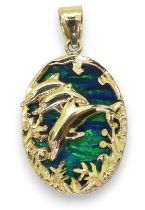 A 14K DOLPHIN PENDANT set with a large piece of man made opal of approx 2.4cm x 1.8cm, length of