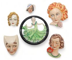 SIX GOEBEL POTTERY WALL MASKS including a circular example with a girl in green dress dancing,