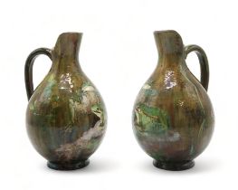 A PAIR OF FRENCH POTTERY EWERS each painted with two frogs on naturalistic ground, each signed to