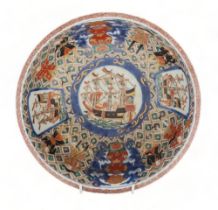 AN IMARI 'BLACK SHIP' BOWL decorated with ships and figures on a diaper pattern ground, 25.5cm