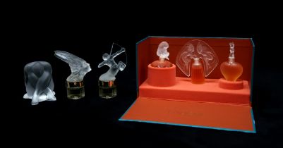 A BOXED SET OF LALIQUE ULTIMATE COLLECTION PERFUME BOTTLES including Le Nu 1996, Armour 1997 and