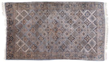 A GREEN GROUND QASHQAI RUG  with all over geometric lozenge patterned ground within geometric floral