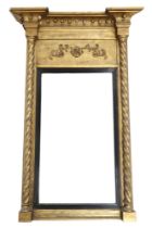 A REGENCY GILT FRAMED WALL MIRROR  with moulded cornice with ball decoration over scrolled floral