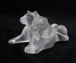 A LALIQUE CRYSTAL FIGURE OF LION CUBS in frosted clear glass, signed to base Lalique France, 11.