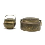 A CHINESE BRASS HAND WARMER Decorated with dragons and foliage, swing handle, 26cm diameter and