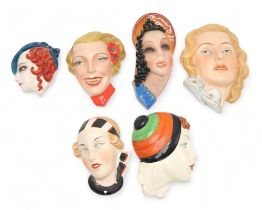 A COLLECTION OF CZECHOSLOVAKIAN ART DECO WALL MASKS all of girls' heads, including a Royal Dux