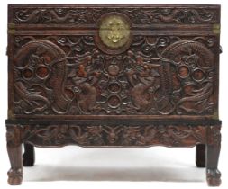 A CHINESE CAMPHORWOOD BLANKET CHEST   Extensively carved with dragons and clouds, a hinged lid,