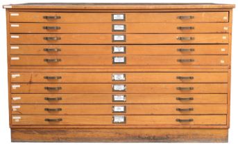 A 20TH CENTURY PITCH PINE PLAN CHEST with laminate top over ten narrow folio drawers on plinth base,