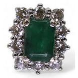 An 18ct white gold diamond and emerald cluster ring, finger size M1/2, weight 5.3gms