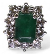 An 18ct white gold diamond and emerald cluster ring, finger size M1/2, weight 5.3gms
